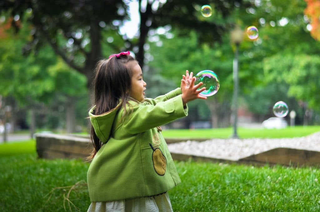 enfant jouant avec une bulle 